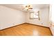 Bedroom with ceiling fan, window with curtains, and light wood-look laminate flooring at 3125 W Ford Pl, Denver, CO 80219