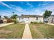 Single-story home with a sidewalk, complemented by tidy landscaping and a cozy bench at 3125 W Ford Pl, Denver, CO 80219