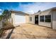 Attached one car garage with concrete driveway, yard access, and ample exterior light at 3125 W Ford Pl, Denver, CO 80219