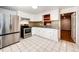 Well-lit kitchen features stainless steel appliances and ample counter space at 3125 W Ford Pl, Denver, CO 80219