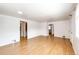 Spacious living room with pristine white walls and beautiful light hardwood flooring at 3125 W Ford Pl, Denver, CO 80219
