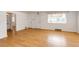 Bright living room with pristine white walls and beautiful hardwood flooring at 3125 W Ford Pl, Denver, CO 80219