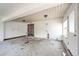 Large sunroom with cement floor, multiple doors, and recessed lighting at 3125 W Ford Pl, Denver, CO 80219