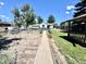 Landscaped backyard featuring a stone walkway that leads to a cozy gazebo at 1270 Havana St, Aurora, CO 80010
