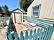 Quaint backyard features a small storage shed and charming, turquoise picket fence at 1270 Havana St, Aurora, CO 80010