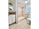 Tiled bathroom with tub, shower, toilet and vanity with white cabinets at 1270 Havana St, Aurora, CO 80010