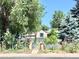 Quaint home hidden behind lush trees and plants creating a private front yard at 1270 Havana St, Aurora, CO 80010