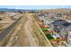 Aerial view showing backyards, fences, community paths and a view of mountains in the background at 718 176Th Ave, Broomfield, CO 80023