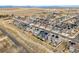 An aerial view showcases a modern residential community with solar panels and mountain views in the distance at 718 176Th Ave, Broomfield, CO 80023