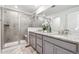 Bathroom featuring double sinks, granite countertop, and walk-in shower at 718 176Th Ave, Broomfield, CO 80023