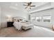 Primary bedroom with a tray ceiling, neutral decor, and a wall of windows at 718 176Th Ave, Broomfield, CO 80023