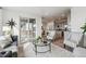 Bright, open living room featuring modern furnishings and a sliding glass door to outdoor deck at 718 176Th Ave, Broomfield, CO 80023