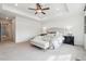 Bright main bedroom with tray ceilings, ceiling fan, carpeted floors, and neutral decor at 718 176Th Ave, Broomfield, CO 80023