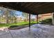 Inviting covered back patio overlooks a lush, landscaped backyard with mature trees and offers a serene outdoor living space at 6336 S Newland Ct, Littleton, CO 80123