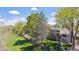 Scenic backyard with mature trees and lush lawn provides a private and serene outdoor retreat at 6336 S Newland Ct, Littleton, CO 80123