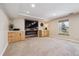 Finished basement with a fireplace, entertainment center, and a neutral-toned carpet at 6336 S Newland Ct, Littleton, CO 80123