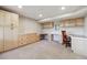 Finished basement offers cabinets, desk space, and neutral-toned carpet at 6336 S Newland Ct, Littleton, CO 80123