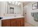 Bathroom with a wood vanity, white countertop, decorative mirror, and neutral paint at 6336 S Newland Ct, Littleton, CO 80123