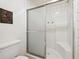 Bathroom featuring a glass-enclosed shower and white tile at 6336 S Newland Ct, Littleton, CO 80123