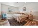 Comfortable bedroom with a window and an accent wall and hardwood floors at 6336 S Newland Ct, Littleton, CO 80123
