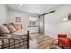 Cozy bedroom with hardwood floors, natural light, and a unique sliding door at 6336 S Newland Ct, Littleton, CO 80123