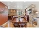 Dining area, showcasing stone accent wall, connecting to the kitchen with hardwood flooring at 6336 S Newland Ct, Littleton, CO 80123