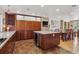 Spacious kitchen and dining area with modern appliances and a center island at 6336 S Newland Ct, Littleton, CO 80123