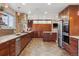 Well-lit kitchen with granite countertops, wood cabinets, and stainless steel appliances at 6336 S Newland Ct, Littleton, CO 80123