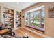 Bright living room with a large window, a window seat, and built-in shelving at 6336 S Newland Ct, Littleton, CO 80123