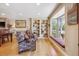 Cozy living room featuring built-in bookshelves, a window seat, and hardwood floors at 6336 S Newland Ct, Littleton, CO 80123