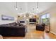 Bright living room featuring a fireplace, stone accent wall, and large windows at 6336 S Newland Ct, Littleton, CO 80123