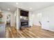 Inviting living room features a fireplace, television, and hardwood floors throughout at 6336 S Newland Ct, Littleton, CO 80123
