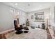 Bright sitting room with hardwood floors, large windows and comfortable seating area at 6336 S Newland Ct, Littleton, CO 80123