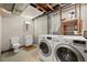 Unfinished basement with a utility sink, toilet, and newer washer dryer units at 3201 W 126Th Ave, Broomfield, CO 80020