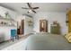 Bedroom featuring an ensuite bathroom, vaulted ceiling and a chair with decoratively placed shelves at 3201 W 126Th Ave, Broomfield, CO 80020
