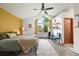 Bright bedroom with a large arched window, vaulted ceiling, and a cozy seating area at 3201 W 126Th Ave, Broomfield, CO 80020