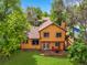 Aerial view of the home showing the lush backyard, deck, and mature trees at 3201 W 126Th Ave, Broomfield, CO 80020