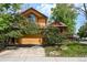 Charming two-story home featuring vibrant yellow siding, red trim, and mature landscaping at 3201 W 126Th Ave, Broomfield, CO 80020