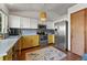 Eat-in kitchen features stainless steel appliances, colorful rug, and white and yellow cabinets at 3201 W 126Th Ave, Broomfield, CO 80020