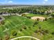 Aerial view showcasing expansive green park with baseball and soccer fields against a mountain backdrop at 3201 W 126Th Ave, Broomfield, CO 80020