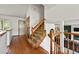 View of the carpeted staircase with wood railing and hardwood floors at 3201 W 126Th Ave, Broomfield, CO 80020