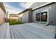 Backyard featuring a wood deck, small grass area, and a sliding glass door that enters into the home at 1365 W 67Th Pl, Denver, CO 80221