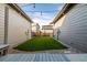 Cozy backyard with low-maintenance artificial grass, gravel, and a wood deck with string lights overhead at 1365 W 67Th Pl, Denver, CO 80221