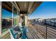 Relax on this covered balcony with blue chairs and enjoy the neighborhood view at 1365 W 67Th Pl, Denver, CO 80221