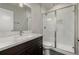 Bathroom featuring a marble vanity and glass enclosed shower, offering style and functionality at 1365 W 67Th Pl, Denver, CO 80221