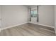 Bedroom with wood flooring, neutral walls, and a large window for natural light at 1365 W 67Th Pl, Denver, CO 80221