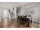 Bright dining room with hardwood floors, staircase access, and modern lighting at 1365 W 67Th Pl, Denver, CO 80221