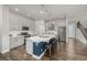 Modern kitchen featuring a large island, stainless steel appliances, and stylish gray cabinetry at 1365 W 67Th Pl, Denver, CO 80221