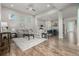 Bright living room with hardwood floors, a ceiling fan, and a view into the kitchen area at 1365 W 67Th Pl, Denver, CO 80221