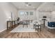 Cozy living room with hardwood floors, neutral decor, and a view of the outdoor patio at 1365 W 67Th Pl, Denver, CO 80221